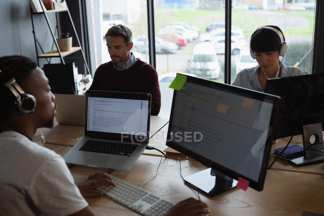 Attentive colleagues working at desk in modern office. — Stock Photo