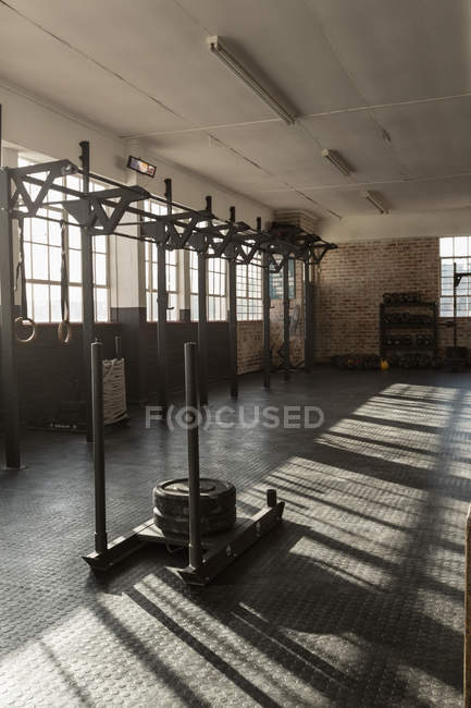 Vista interior do estúdio de fitness com equipamentos à luz solar . — Fotografia de Stock