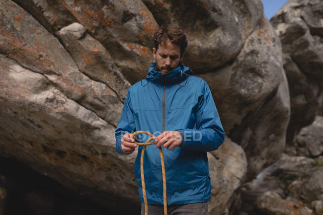 Determine hiker folding climbing rope — Stock Photo