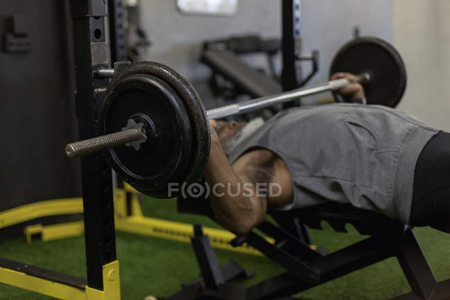 Homem sênior determinado exercitando com barra no estúdio de fitness . — Fotografia de Stock