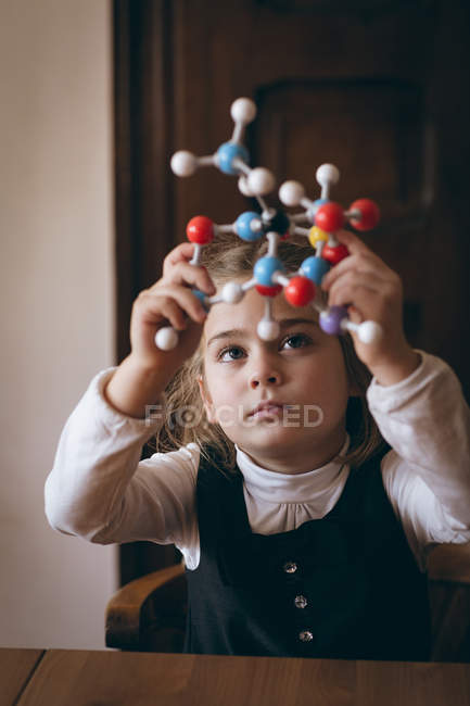 Smart girl experimenting with molecule at home — Stock Photo