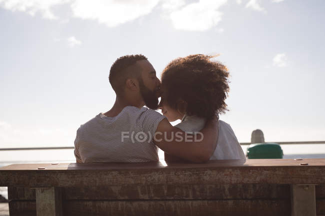 Man kissing woman on forehead near sidewalk — Stock Photo