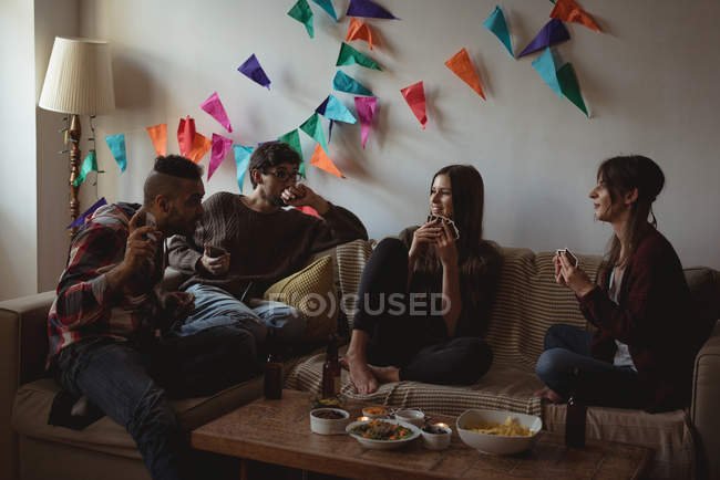 Friends laying cards in living room at home — Stock Photo