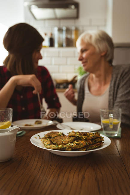 Senior woman and daughter eating omelet for breakfast — Stock Photo
