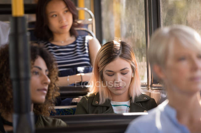 Female commuter travelling in modern bus — Stock Photo