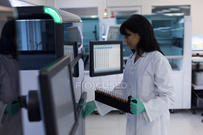 Laboratory technician holding test tubes in blood bank — Stock Photo