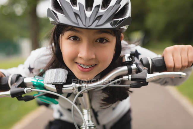 Close-up of girl riding bicycle on street — Stock Photo