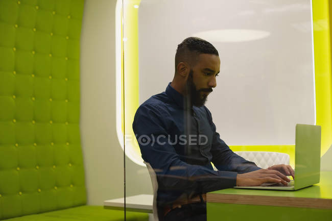Businessman using laptop in desk at office — Stock Photo