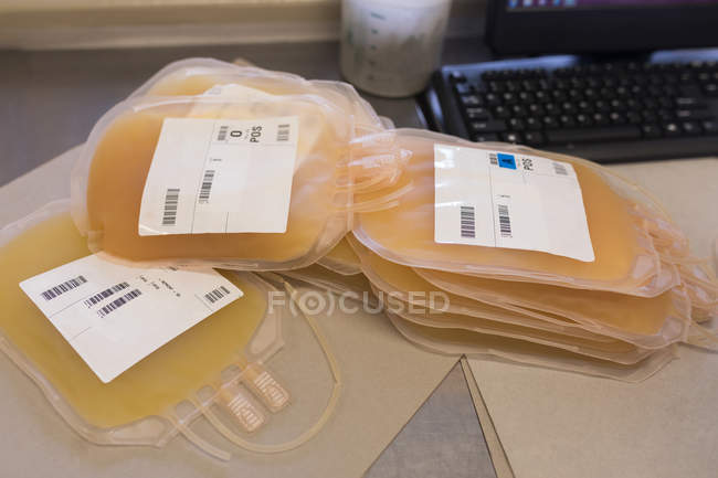 Close-up of plasma bags on a table in blood bank — Stock Photo