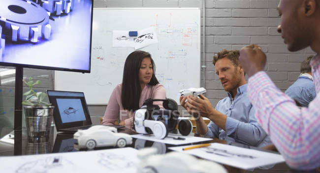 Business colleagues discussing over car model in office — Stock Photo
