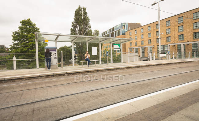 Commuter using ticket vending machine at railway station — Stock Photo