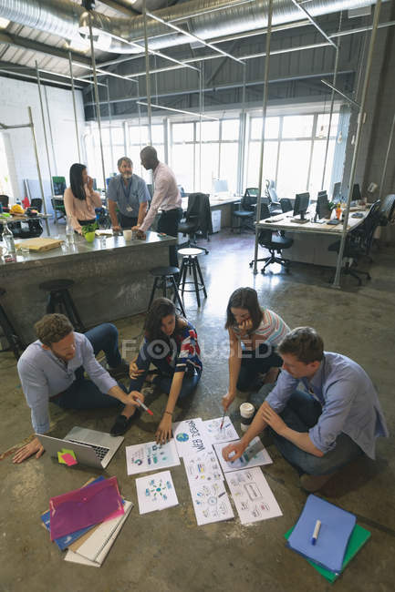 Business people discussing over documents in office — Stock Photo