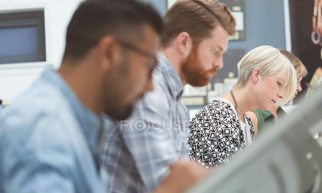 Close-up of executives working on drafting table in office — Stock Photo