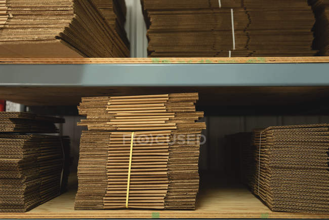 Paper bags arranged in rack at warehouse — Stock Photo