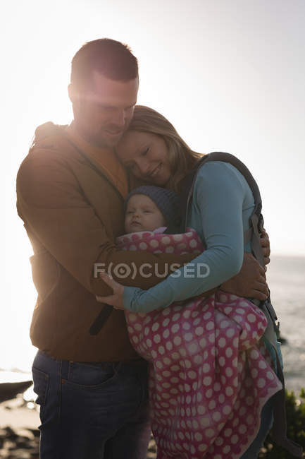 Close-up of parents with baby standing on beach — Stock Photo