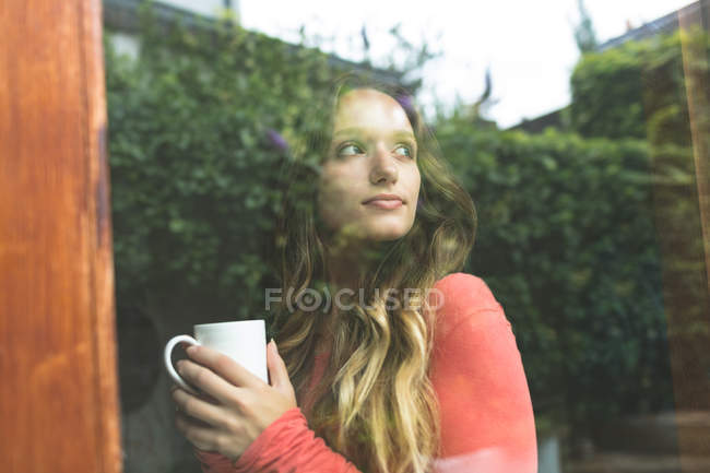 Thoughtful woman having coffee at home — Stock Photo