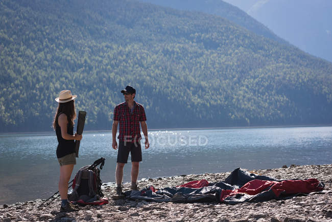 Romantic couple interacting with each other near riverside — Stock Photo