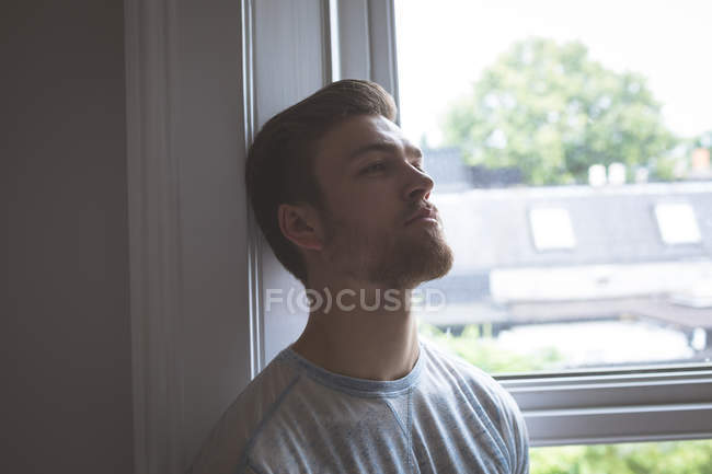 Worried man standing at home — Stock Photo