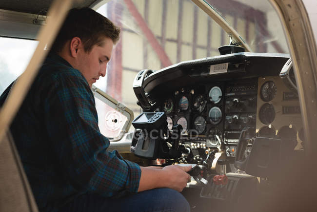 Side view of engineer operating cockpit — Stock Photo