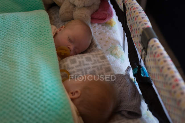 Siblings sleeping together on bed at home — Stock Photo
