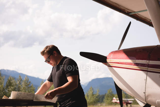 Side view of mechanic working at aerospace hangar — Stock Photo