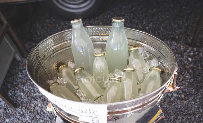 Close-up of cold drinks in bucket with ice — Stock Photo
