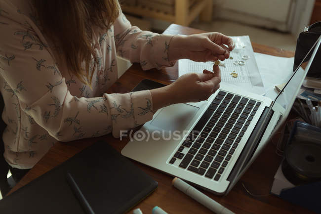 Mid section of jewelry designer working in workshop — Stock Photo
