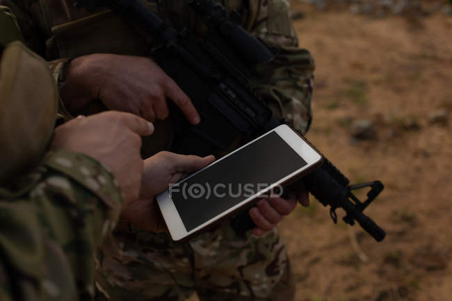 Military soldiers using digital tablet during military training — Stock Photo