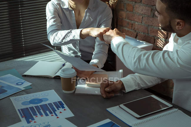 Executives celebrating success with fist bump in office — Stock Photo
