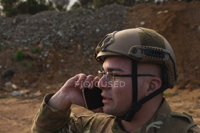 Military soldier talking on mobile phone during military training — Stock Photo