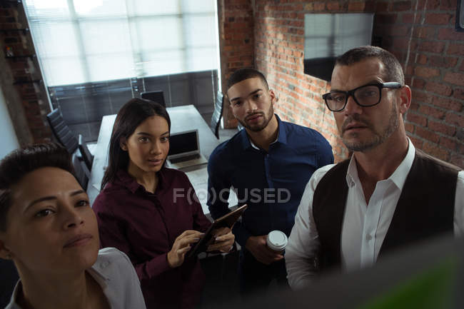 Executives standing in conference room at office — Stock Photo