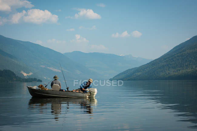 Two fishermen fishing in the river on a sunny day — Stock Photo