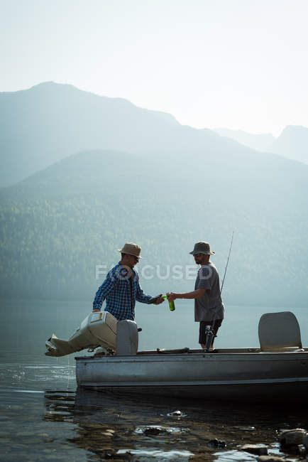 Two fishermen preparing for fishing at countryside on a sunny day — Stock Photo
