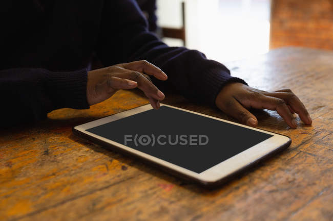 Schoolkid using digital tablet in classroom at school — Stock Photo