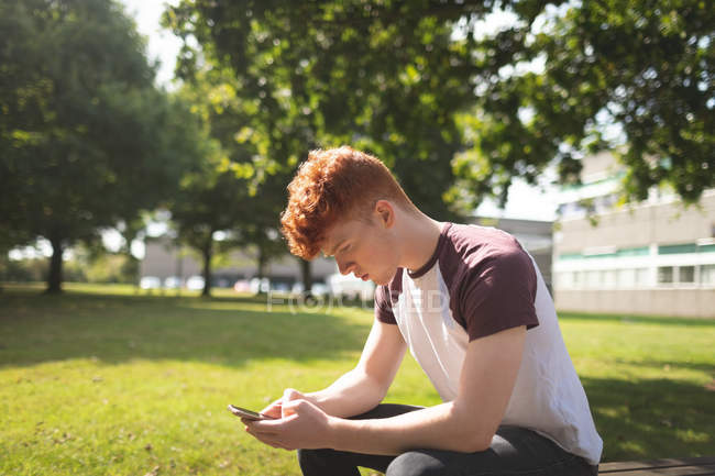 College student using mobile phone in campus — Stock Photo