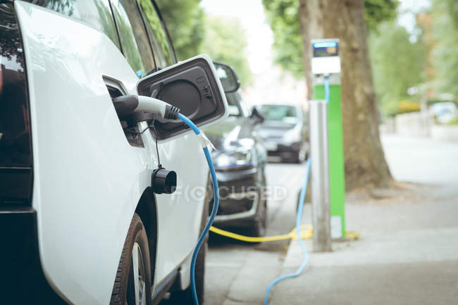 Side view of electric car charging at charging station — Stock Photo