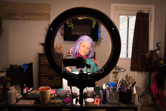 Woman painting her body for halloween celebration — Stock Photo