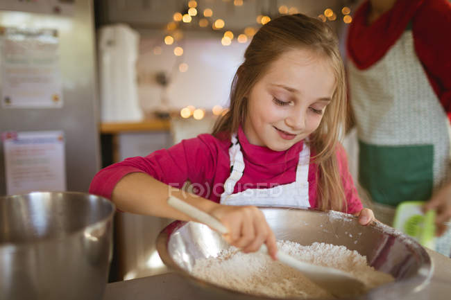 Girl preparing the dough for Christmas cookies at home — Stock Photo