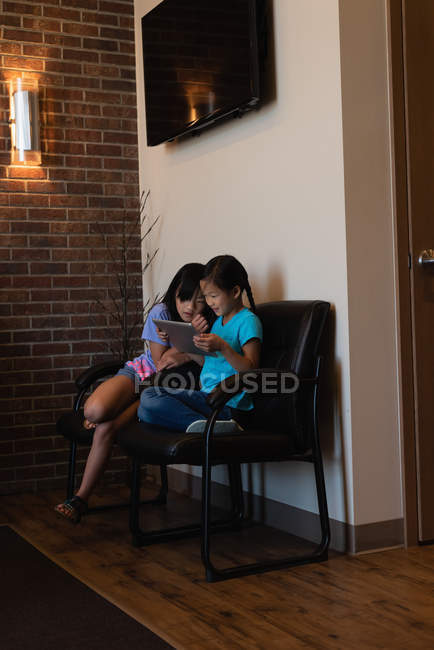 Siblings using digital tablet together in dental clinic — Stock Photo