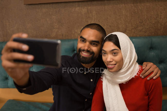 Casal feliz tomando selfie no café — Fotografia de Stock