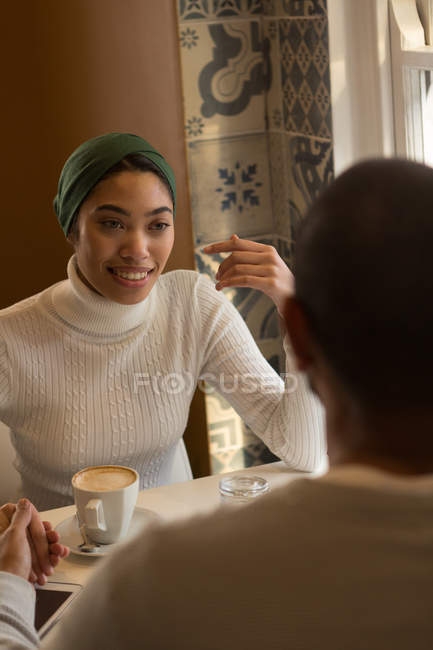 Happy couple interacting with each other in cafe — Stock Photo