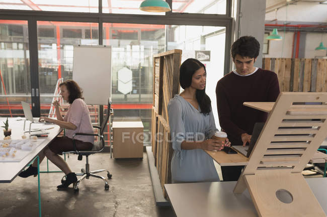 Executives working on laptop in office — Stock Photo