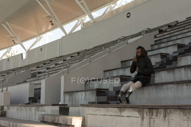 Young disabled athlete wearing hoodie at sports venue — Stock Photo