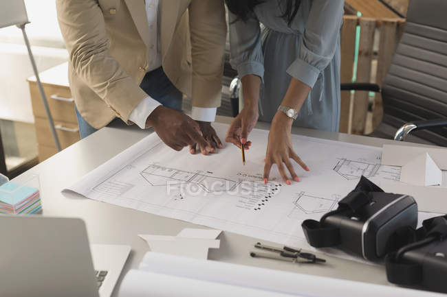 Mid section of business people using invisible digital tablets in meeting — Stock Photo