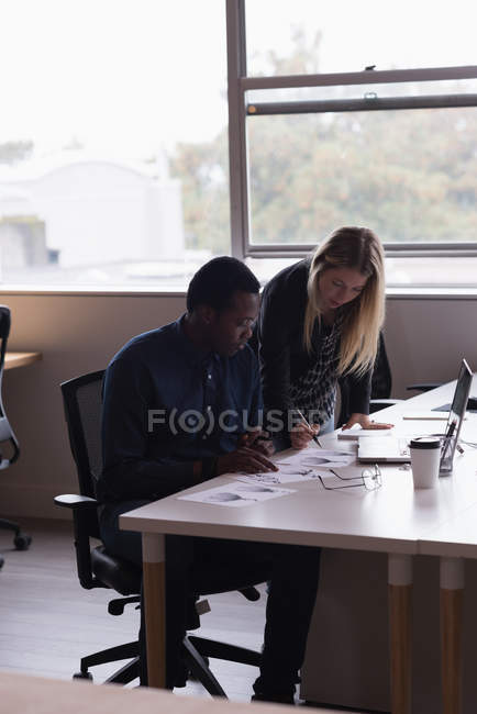 Concentrated businessman and businesswoman working in the office — Stock Photo