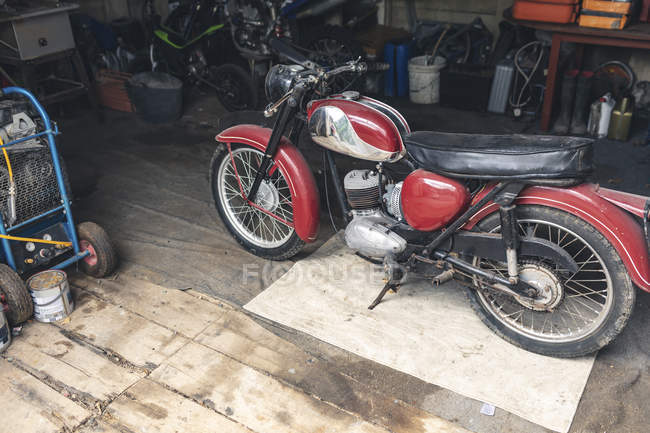 Motorbike standing in repair garage — Stock Photo