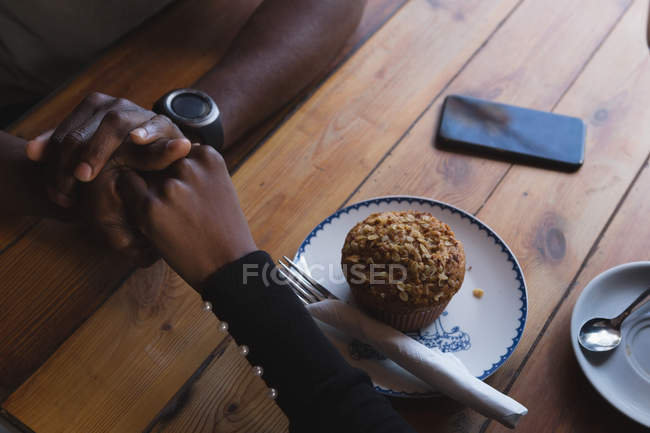 Overhead of couple holding hand in cafe — Stock Photo