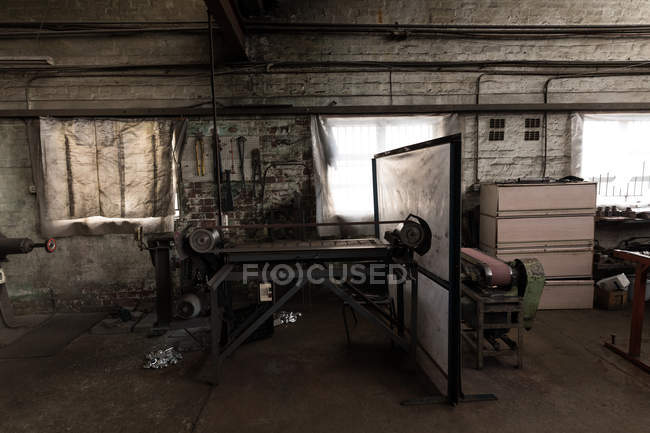 Metal polishing machine in empty workshop — Stock Photo