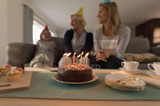 Multi-generation family celebrating birthday in living room at home — Stock Photo