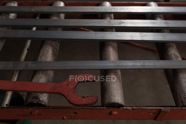 Крупный план плоского металлического стержня и гаечного ключа организован в мастерской — стоковое фото